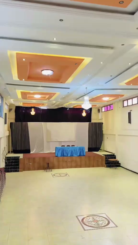 Main banquet and conference hall at Gibe Hotel with raised stage and decorative ceiling lighting
